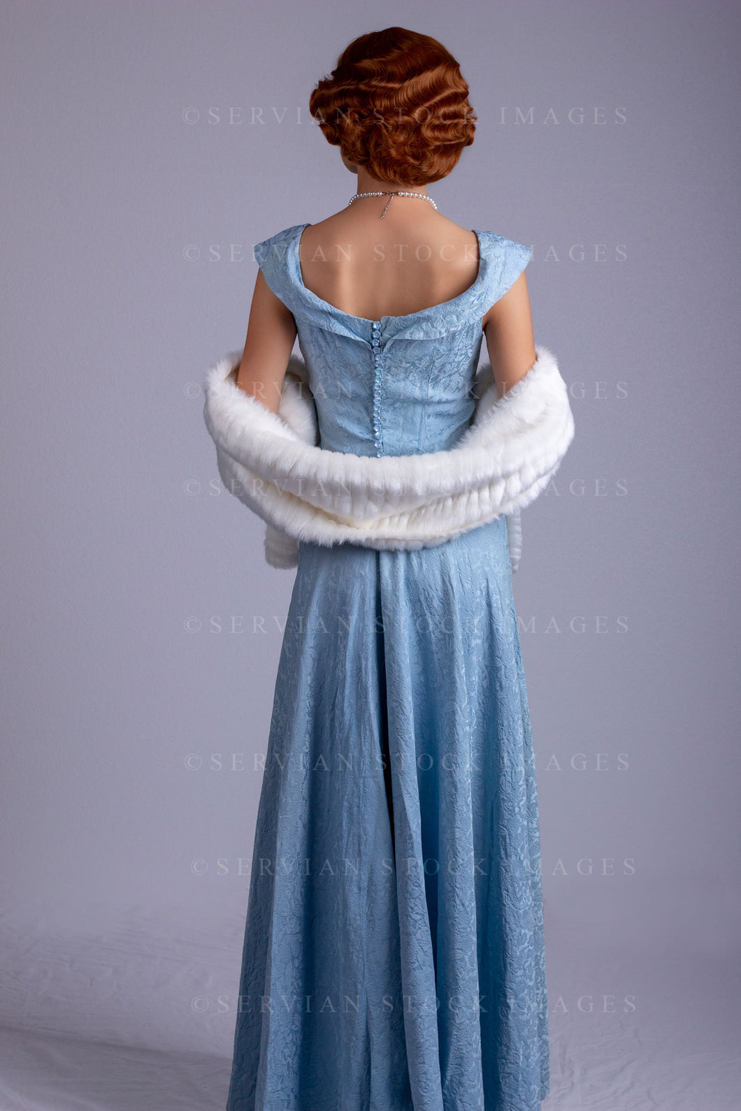 1930s woman wearing a blue vintage dress and a long string of pearls and white fur wrap (Sarah 0172) 1930s woman wearing a blue vintage dress and a long string of pearls and white fur wrap (Sarah 0172)