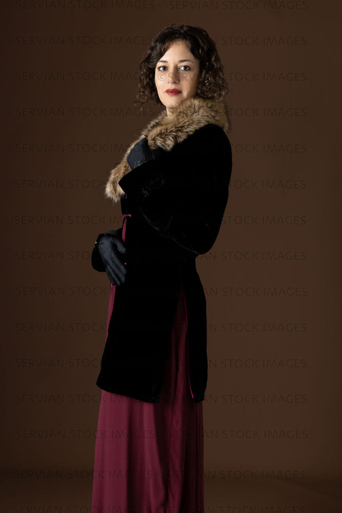 1920s woman wearing a black velvet coat with a dark red day dress (Emma 245)
