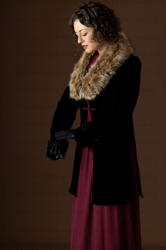 1920s woman wearing a black velvet coat with a dark red day dress (Emm Servian Stock Images 1920s woman wearing a black velvet coat with a dark red day dress (Emm Servian Stock Images