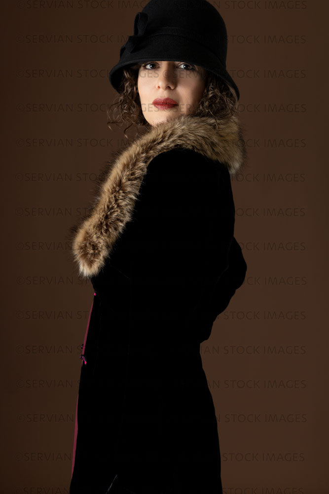1920s woman wearing a black velvet coat and cloche hat (Emma 283)