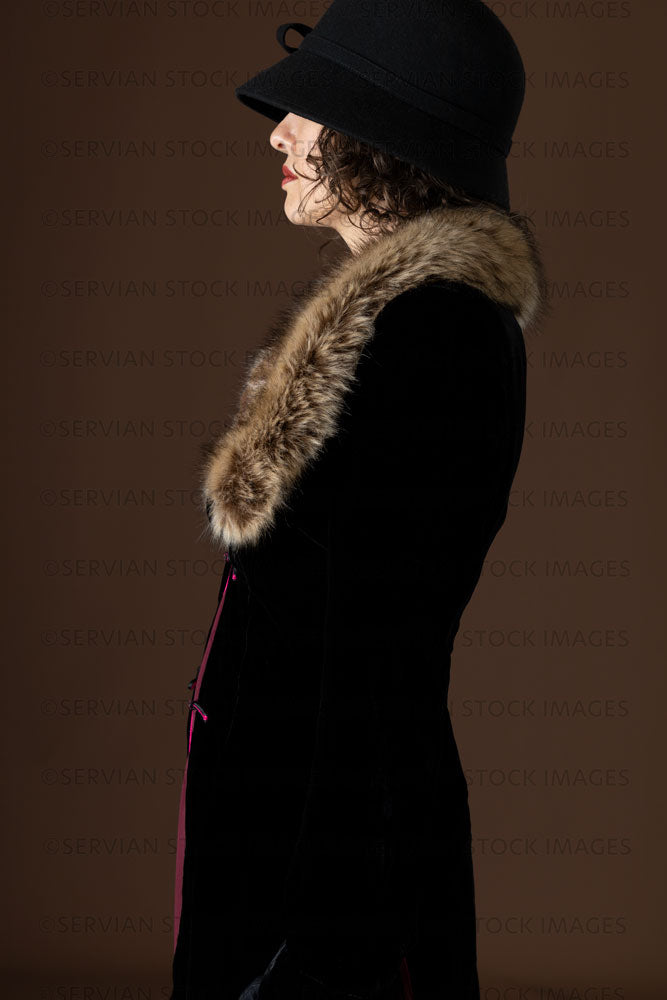 1920s woman wearing a black velvet coat and cloche hat (Emma 285)