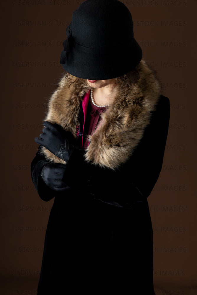 1920s woman wearing a black velvet coat and cloche hat (Emma 301)