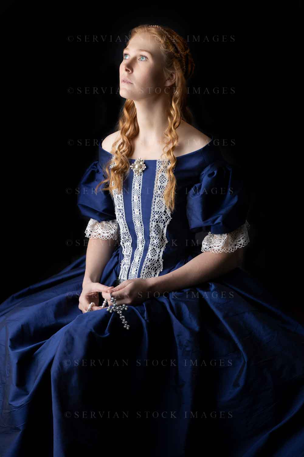 Renaissance woman in a blue silk dress against a black backdrop (Lauren 0620)