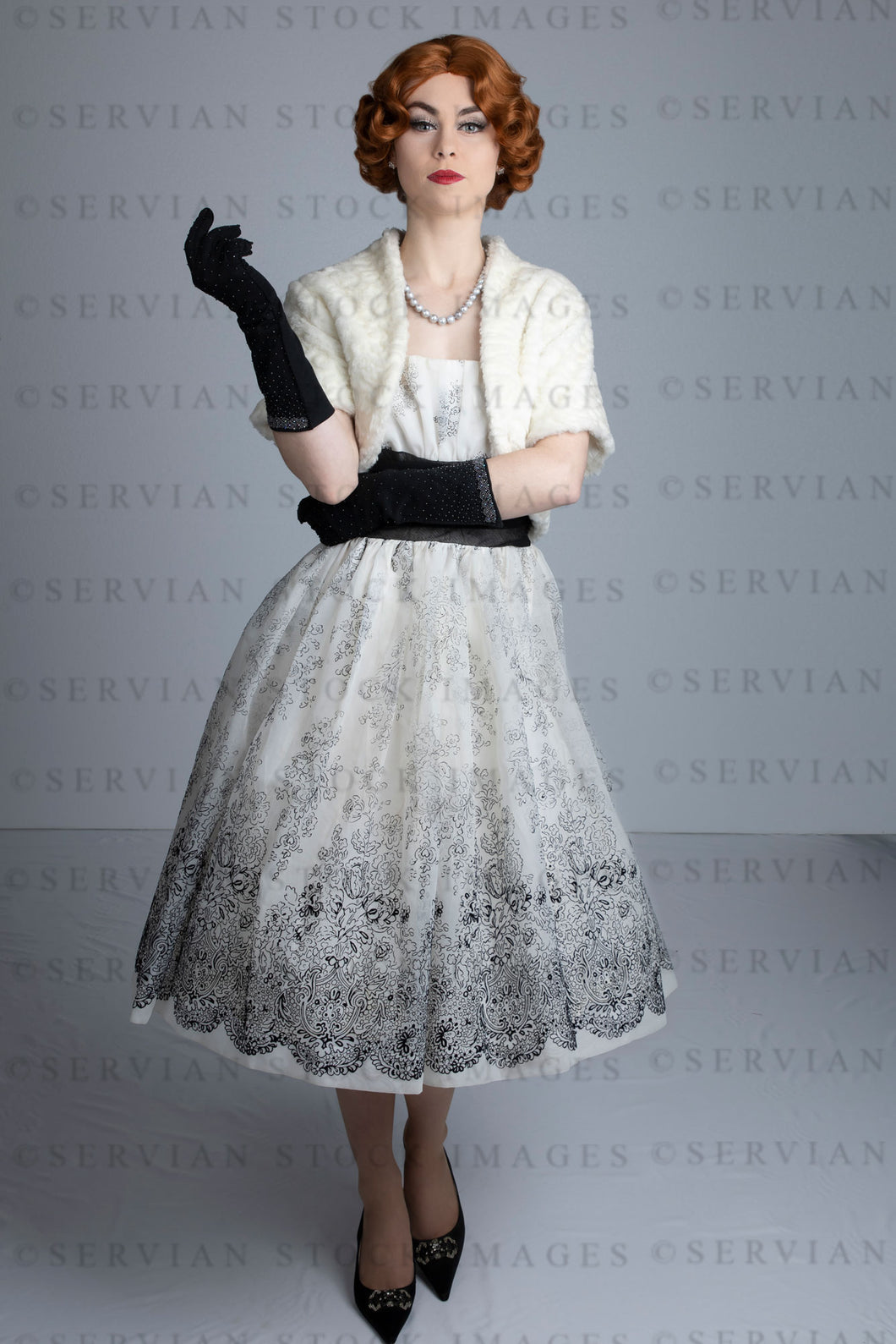 1950s woman in vintage dress, white fur shrug, and black gloves (Lacey 2494)