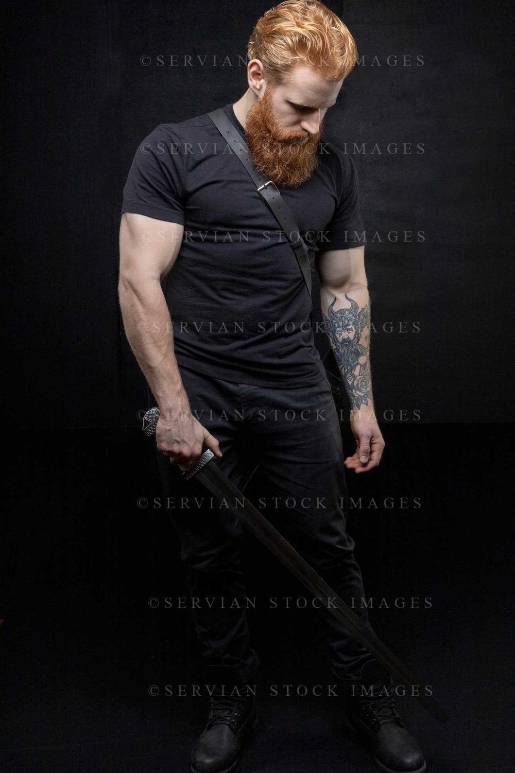 Urban fantasy man with a beard and a large tattoo against a black backdrop (Luke 2996)