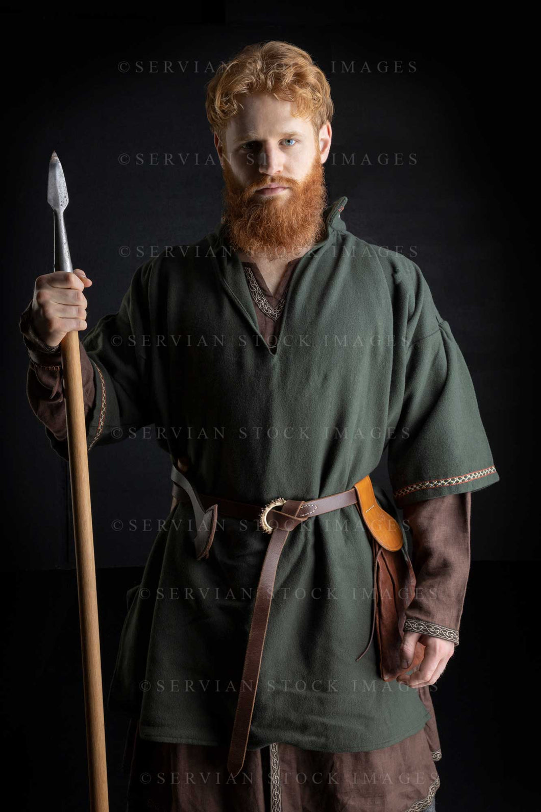 Viking or high fantasy man with red hair and beard holding a spear against a black backdrop (Luke 3054)