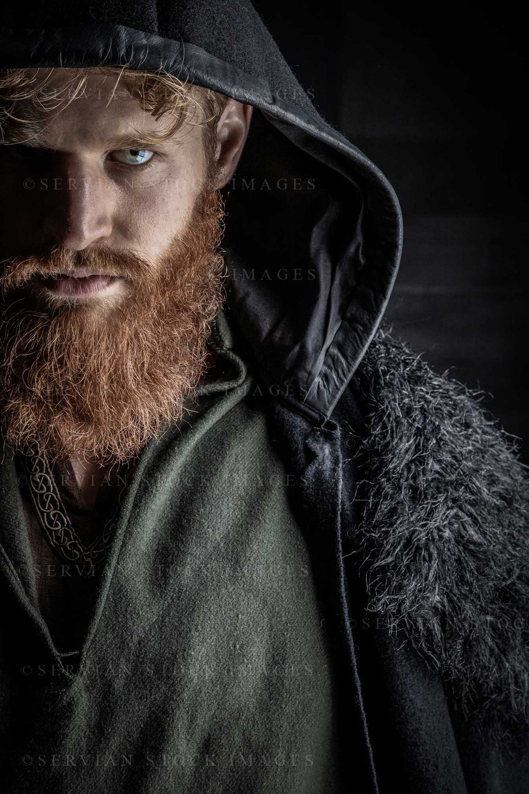 Viking or high fantasy man with red hair and beard wearing a black cloak against a black backdrop (Luke 3194-2)