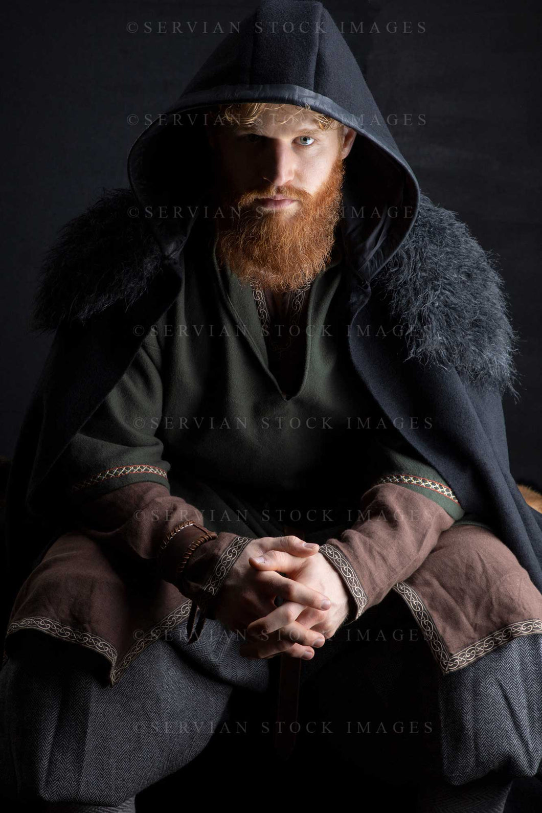 Viking or high fantasy man with red hair and beard wearing a black cloak against a black backdrop (Luke 3196)