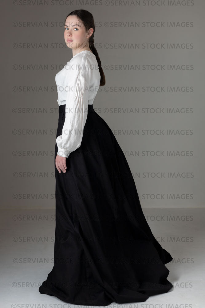Young Victorian / Edwardian woman wearing a white linen blouse and black skirt (Kate 557)