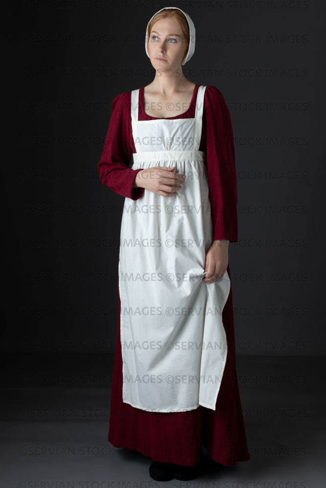 Regency maid or working class woman wearing a red dress, apron, and cap (Lauren 06201)