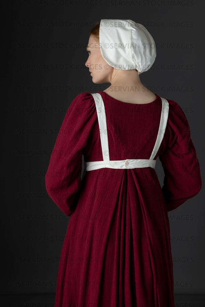 Regency maid or working class woman wearing a red dress, apron, and cap (Lauren 06581)