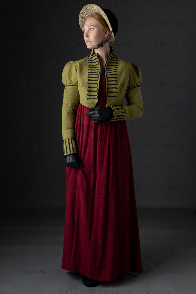 Regency woman wearing a red dress with a green short spencer and bonnet (Lauren 0742)