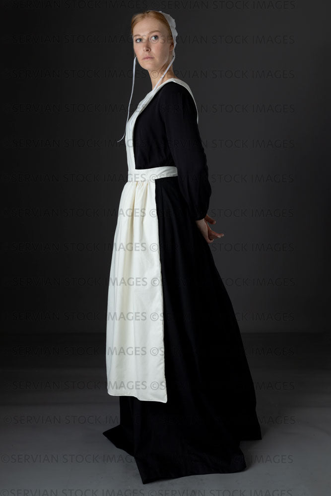 Amish woman wearing a black dress with a white apron and cap (Lauren 0764)