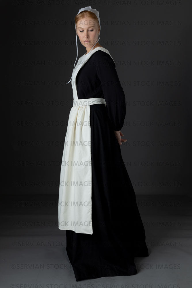 Amish woman wearing a black dress with a white apron and cap (Lauren 0765)