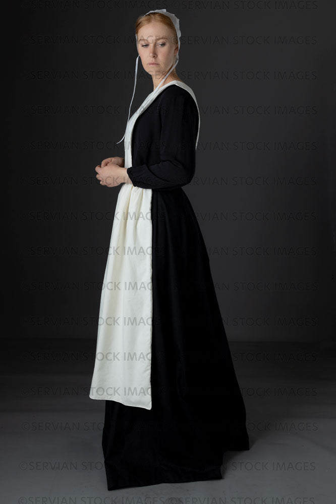 Amish woman wearing a black dress with a white apron and cap (Lauren 0768)