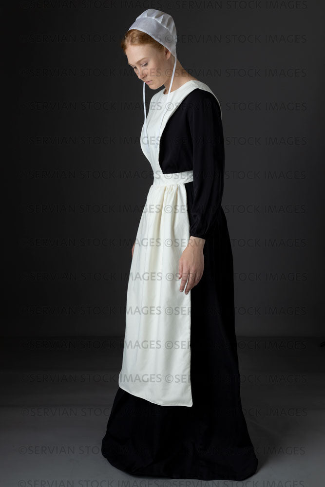Amish woman wearing a black dress with a white apron and cap (Lauren 0770)
