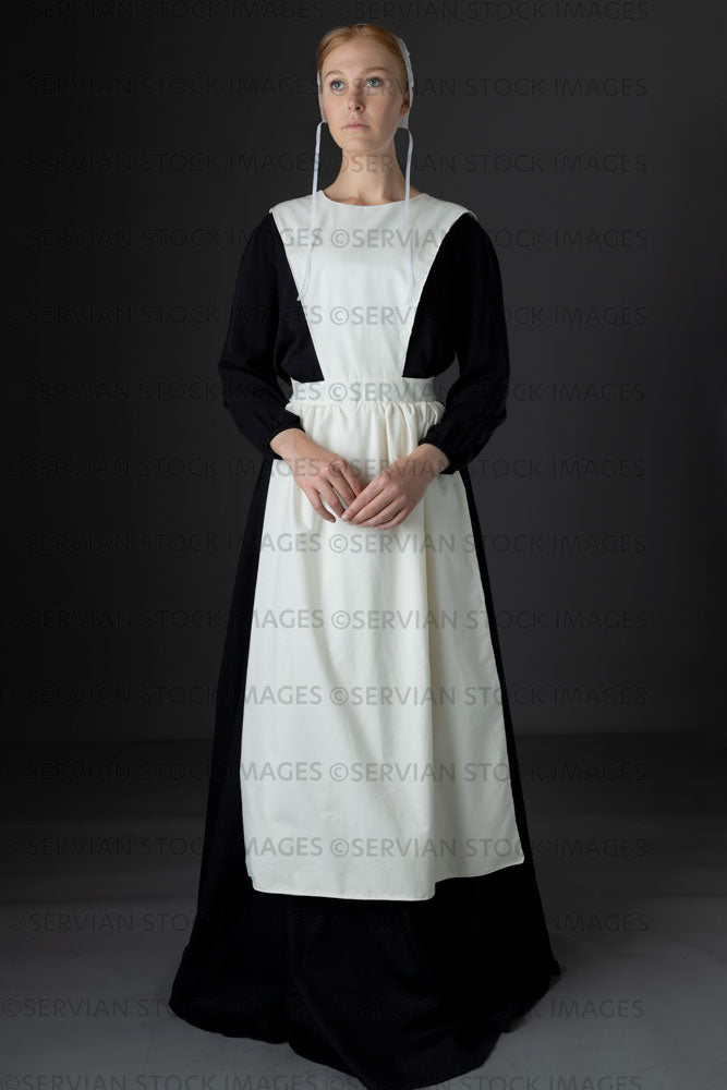 Amish woman wearing a black dress with a white apron and cap (Lauren 0775)