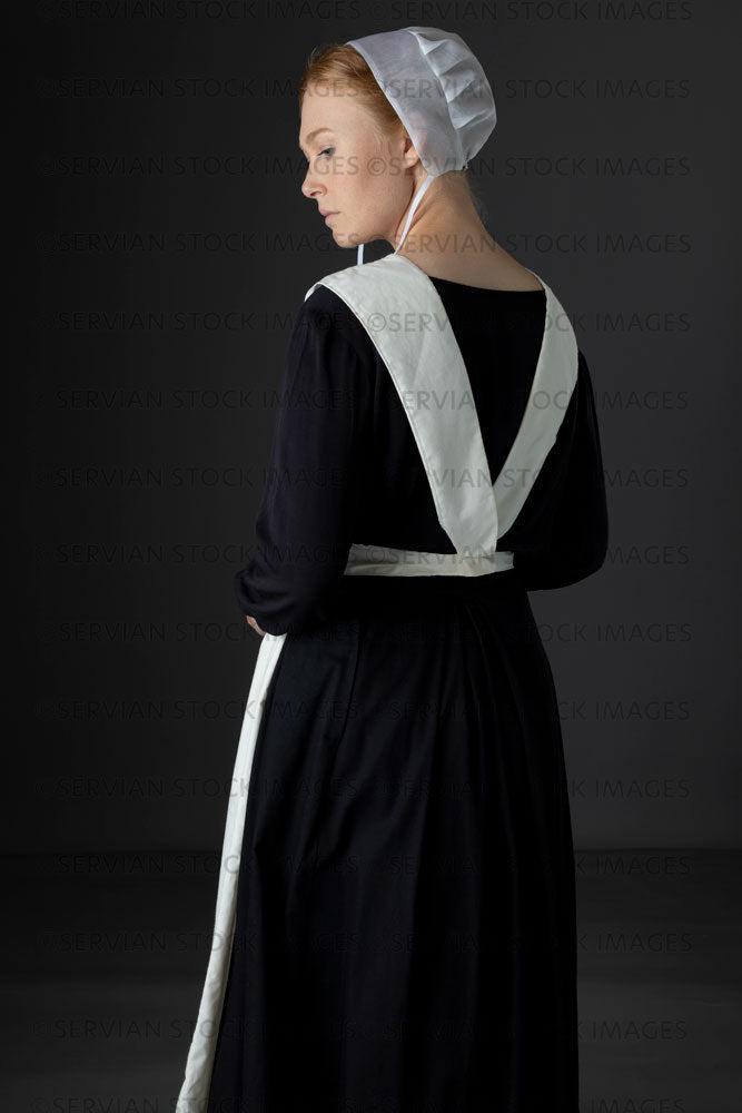 Amish woman wearing a black dress with a white apron and cap (Lauren 0789)