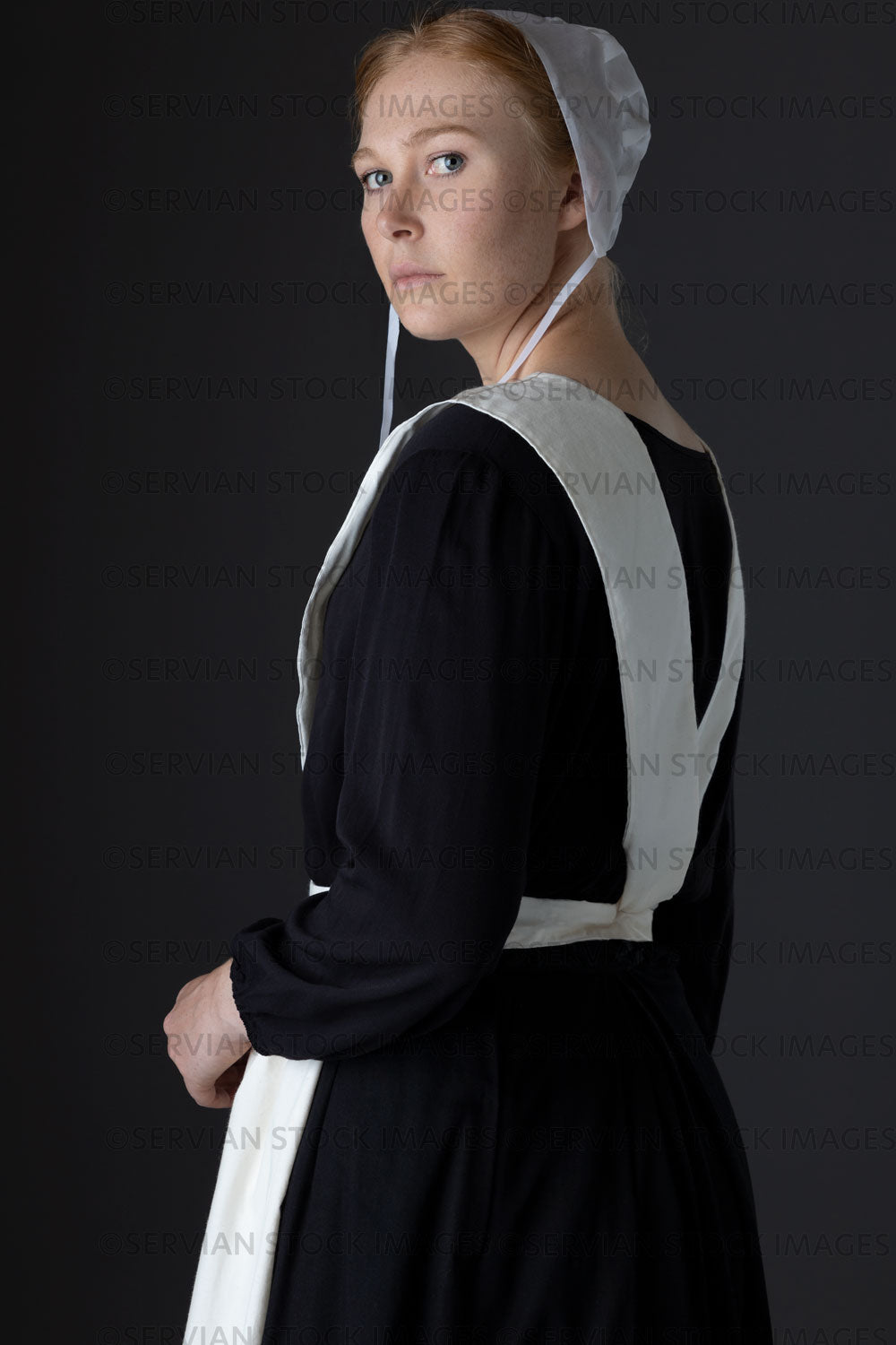 Amish woman wearing a black dress with a white apron and cap (Lauren 0792)