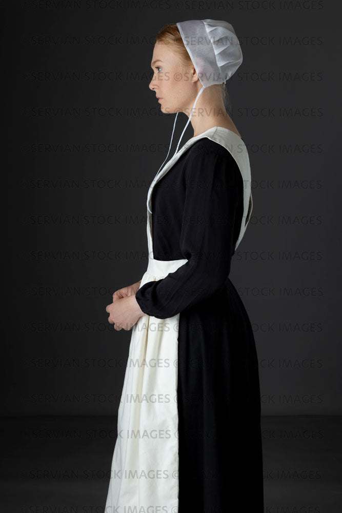 Amish woman wearing a black dress with a white apron and cap (Lauren 0796)