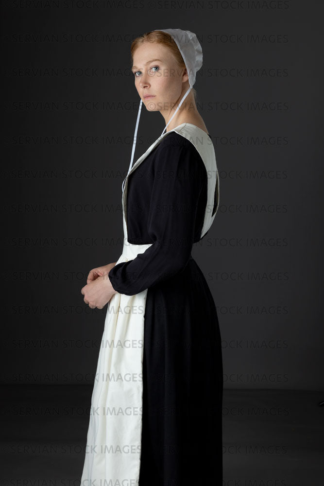 Amish woman wearing a black dress with a white apron and cap (Lauren 0797)
