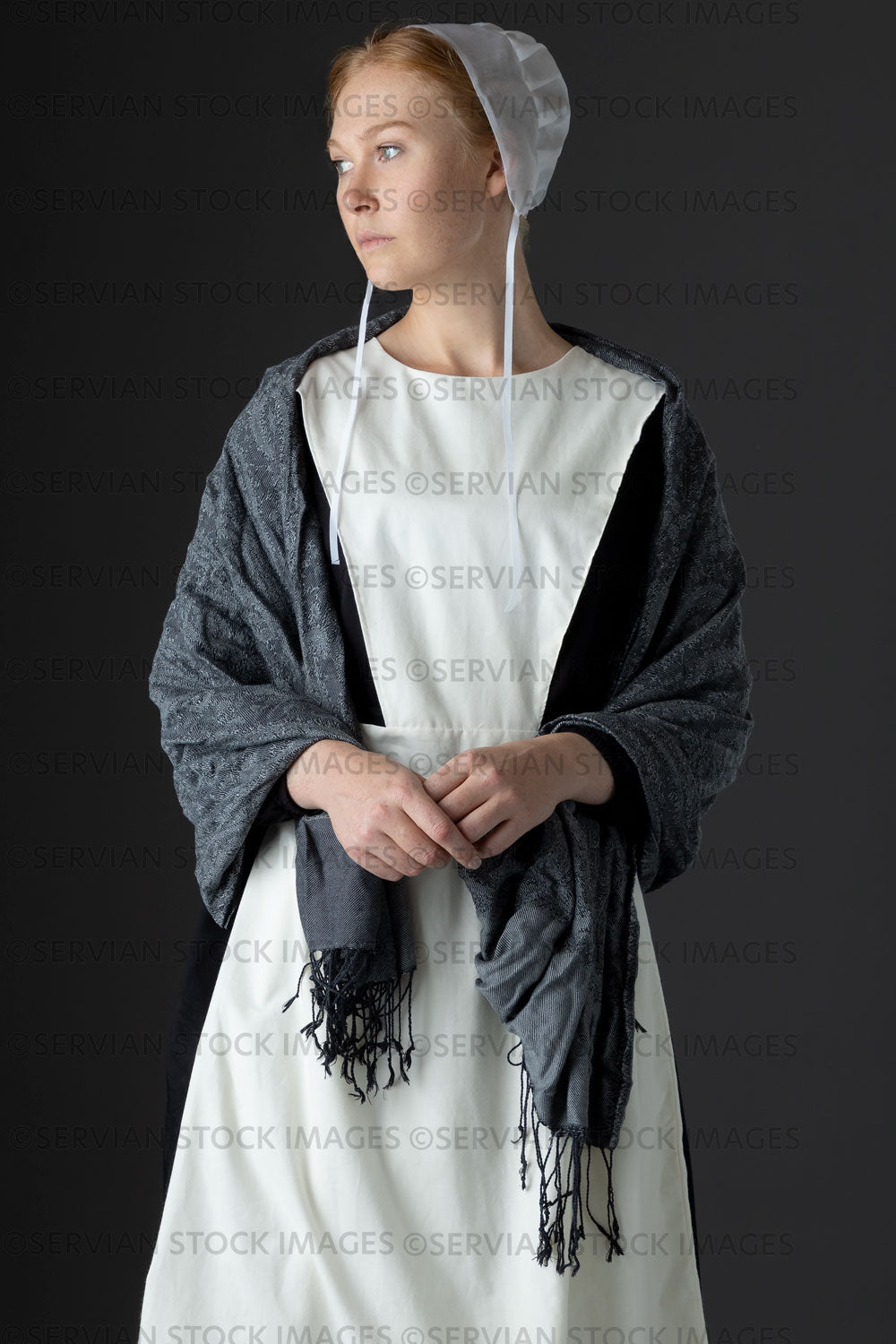 Amish woman wearing a black dress with a white apron and cap (Lauren 0809)