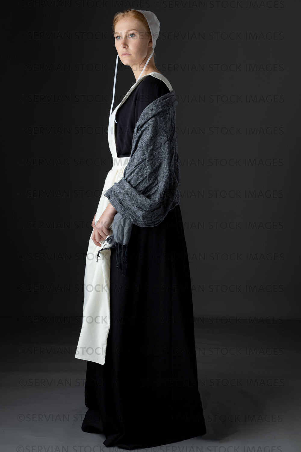 Amish woman wearing a black dress with a white apron and cap (Lauren 0821)
