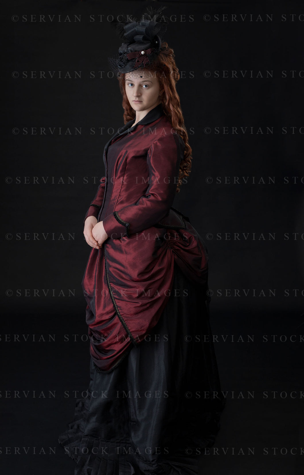 Victorian woman in a bustle ensemble against a black backdrop (Bianca 1068)