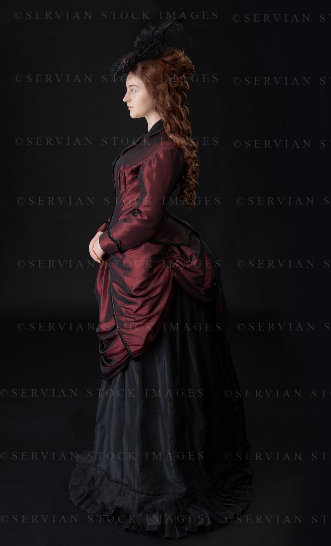 Victorian woman in a bustle ensemble against a black backdrop (Bianca 1039)