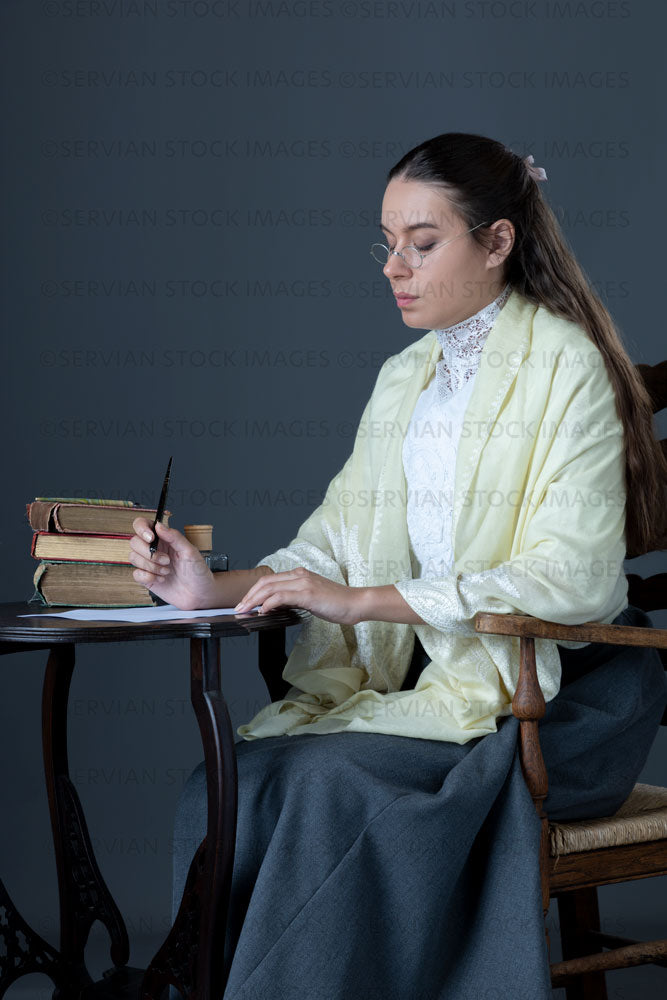 Victorian or Edwardian woman with long hair sitting at a desk writing a letter  (Sarah 1666)