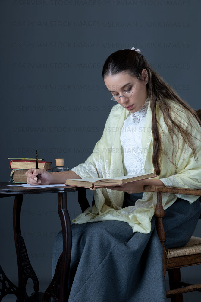 Victorian or Edwardian woman with long hair sitting at a desk writing a letter  (Sarah 1672)