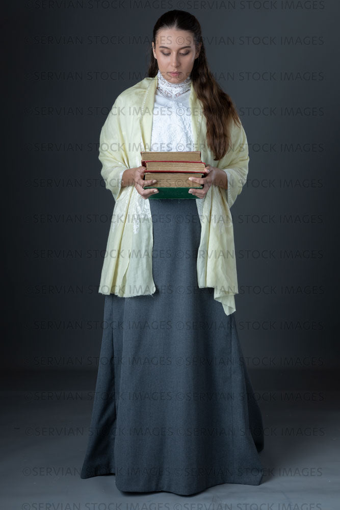 Victorian or Edwardian woman with long hair standing and holding a pile of books  (Sarah 1675)