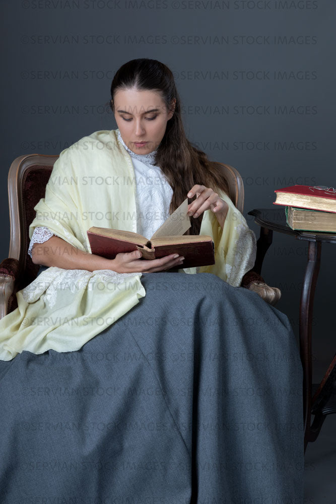 Victorian or Edwardian woman with long hair sitting in a chair reading a book  (Sarah 1695)
