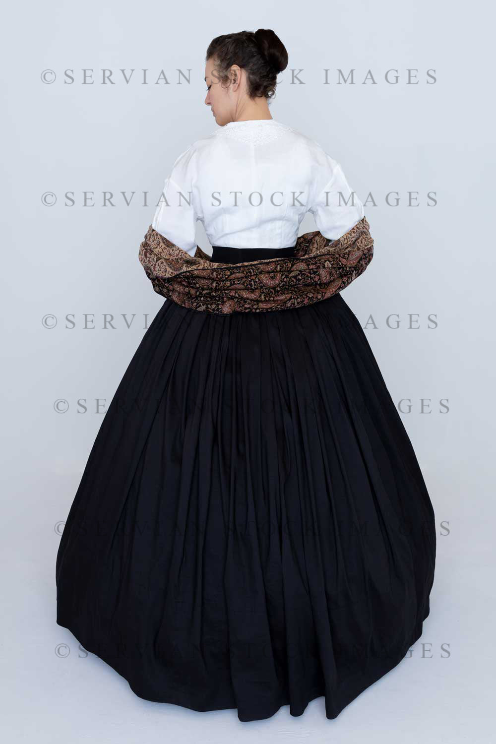 Victorian woman wearing a Garibaldi blouse, paisley shawl and full skirt against a white backdrop (Emma 2356)