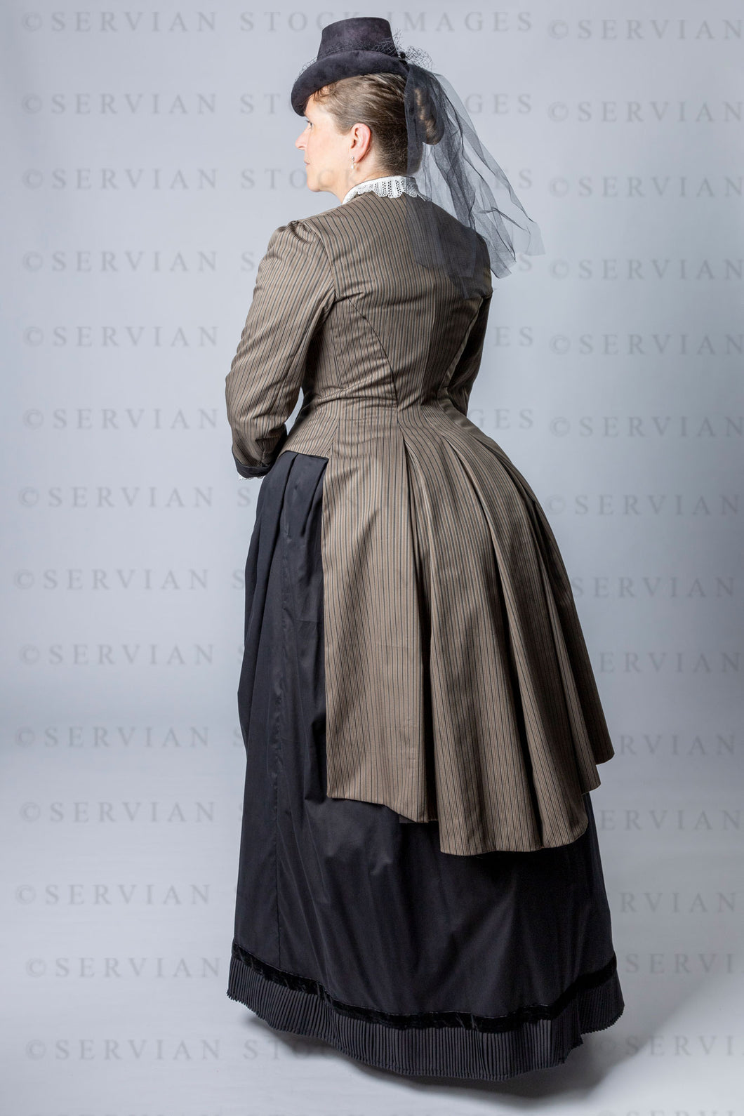 Victorian woman wearing a cuirass bodice and bustle skirt (Tracey 2950)