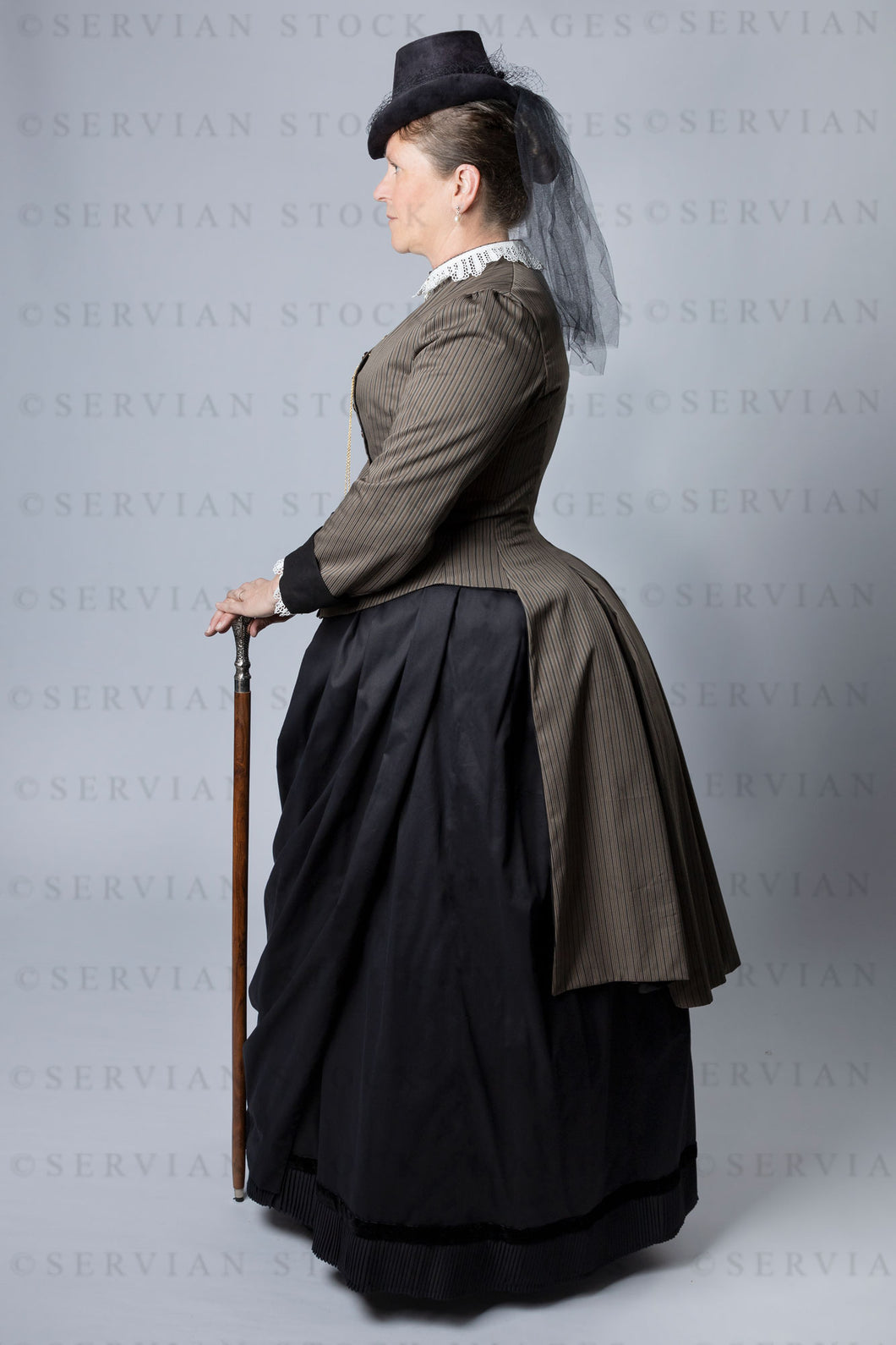 Victorian woman wearing a cuirass bodice and bustle skirt (Tracey 2952)