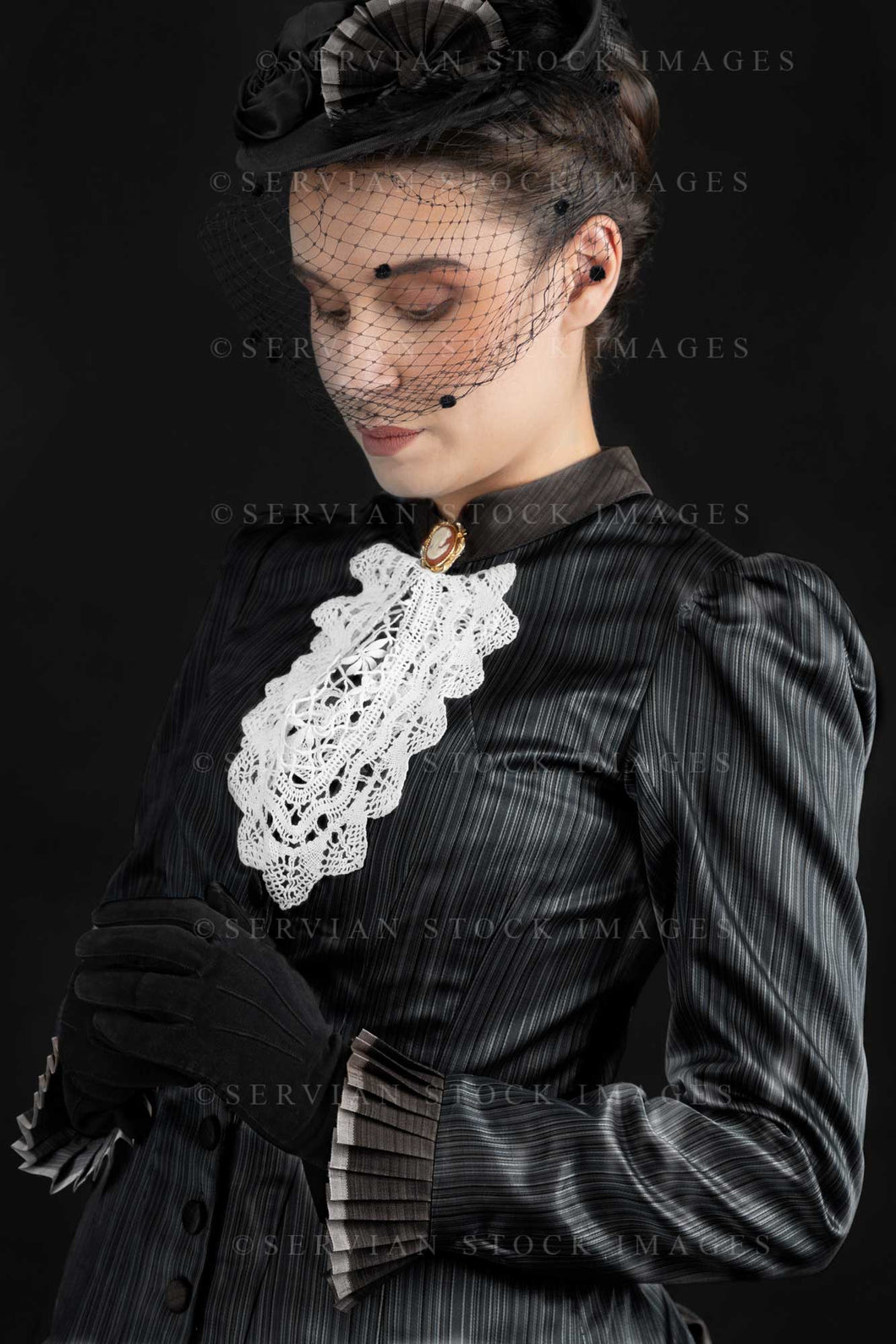 Victorian woman in an 1880s bustle ensemble against a black backdrop (Sarah 3079)