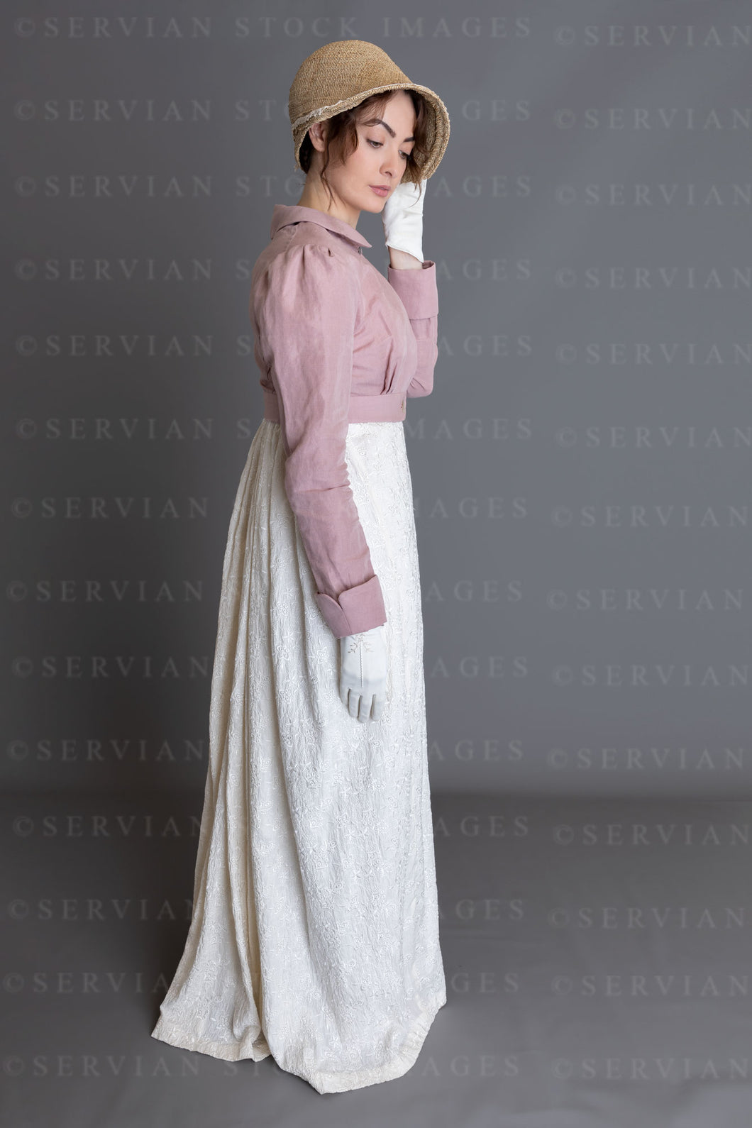 Regency woman in a cream embroidered dress and pink linen short spence Servian Stock Images Regency woman in a cream embroidered dress and pink linen short spence Servian Stock Images