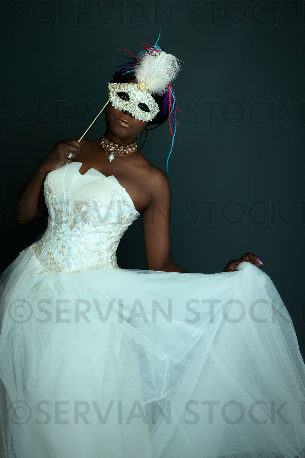 Contemporary woman wearing a white gown and masquerade mask (Marlaina Servian Stock Images Contemporary woman wearing a white gown and masquerade mask (Marlaina Servian Stock Images