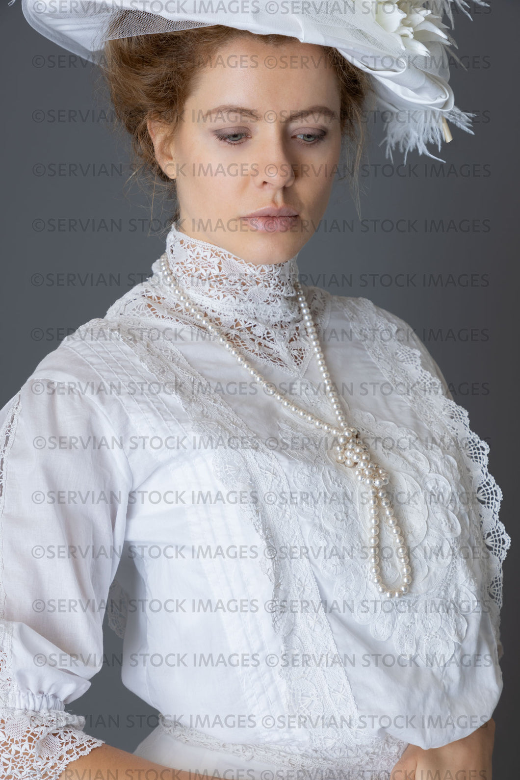 Edwardian woman in a white lace blouse and skirt with a pearl necklace and large hat (Anastasiya 4953)