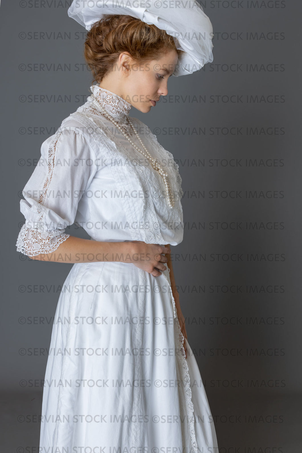 Edwardian woman in a white lace blouse and skirt with a pearl necklace and large hat (Anastasiya 4956)