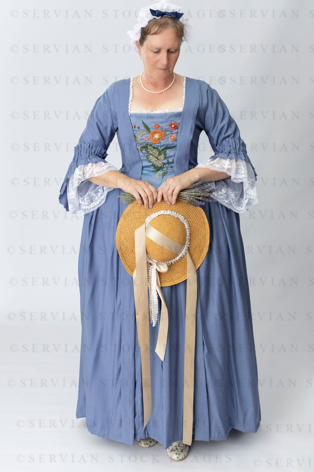 Georgian woman in a blue polonaise and underskirt with an embroidered stomacher (Tracey 4981)