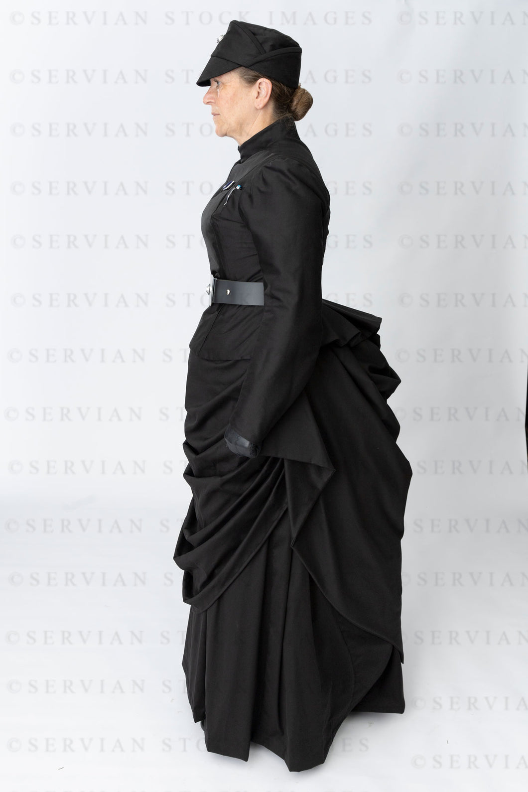 Victorian woman in a black bustle ensemble (Tracey 5031)