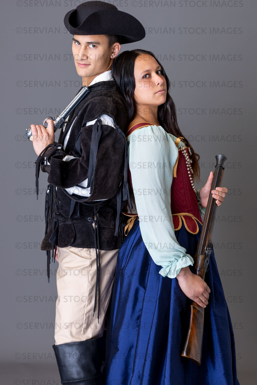 Pirate couple holding weapons against a grey backdrop (Sylvia and Lukas 5987)