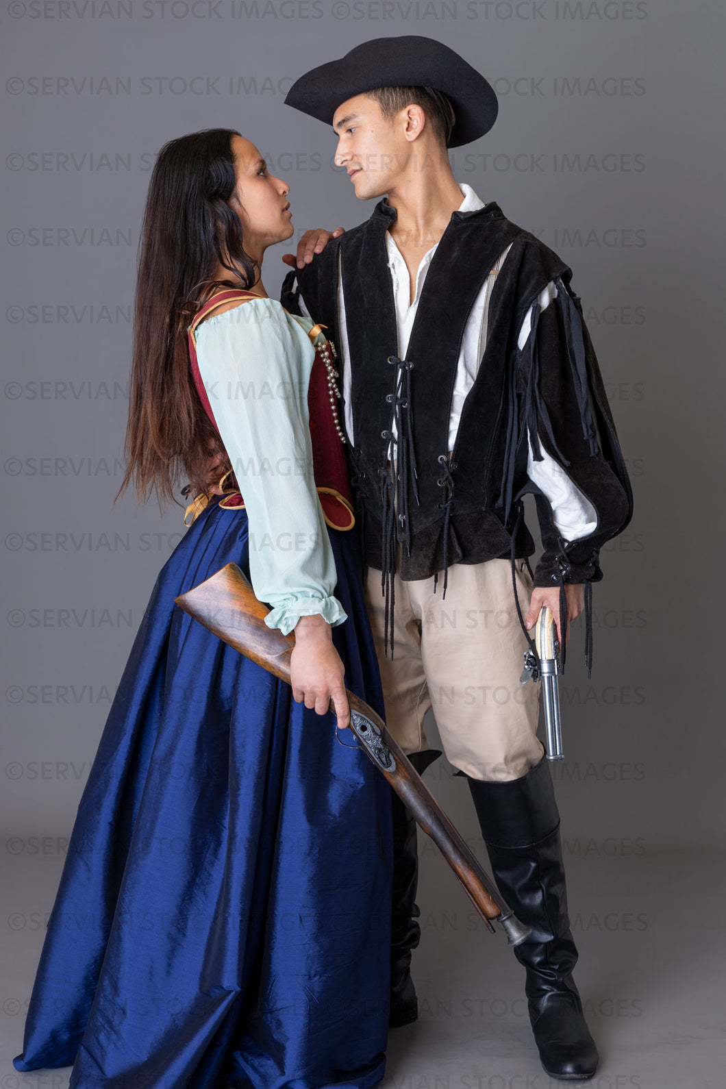 Pirate couple holding weapons against a grey backdrop (Sylvia and Lukas 5992)