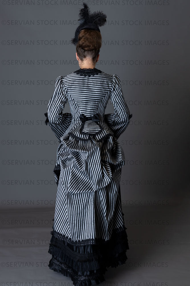 Victorian woman in a striped silk 1870s bustle ensemble  (Sarah 8814)