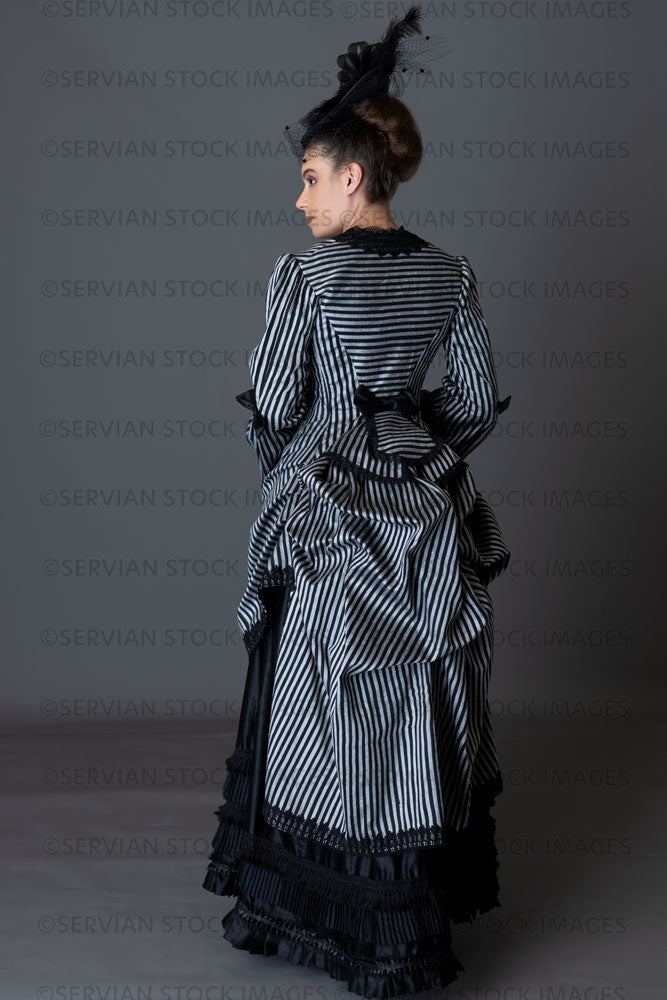 Victorian woman in a striped silk 1870s bustle ensemble  (Sarah 8816)