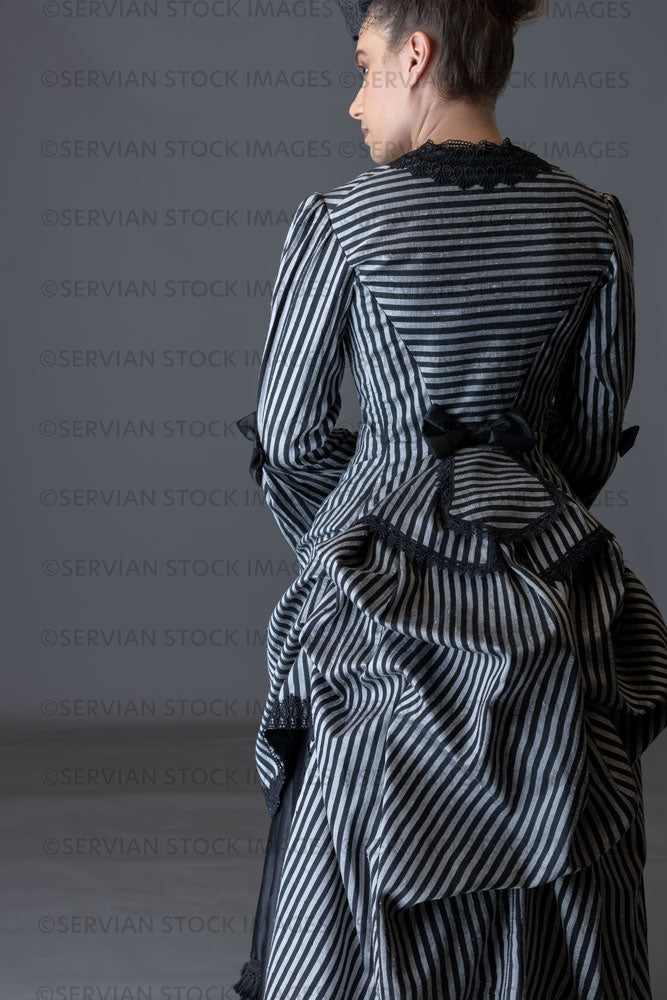 Victorian woman in a striped silk 1870s bustle ensemble  (Sarah 8819)