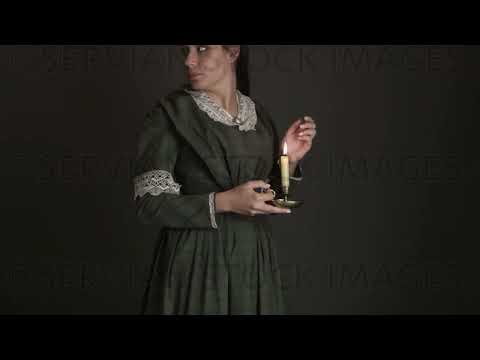 Victorian woman with her hair out and wearing a dark green check bodice and skirt carries a candle    (Sarah 1711)