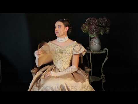 Video of Victorian woman wearing a gold bodice and skirt and using a fan (Sarah 1501)